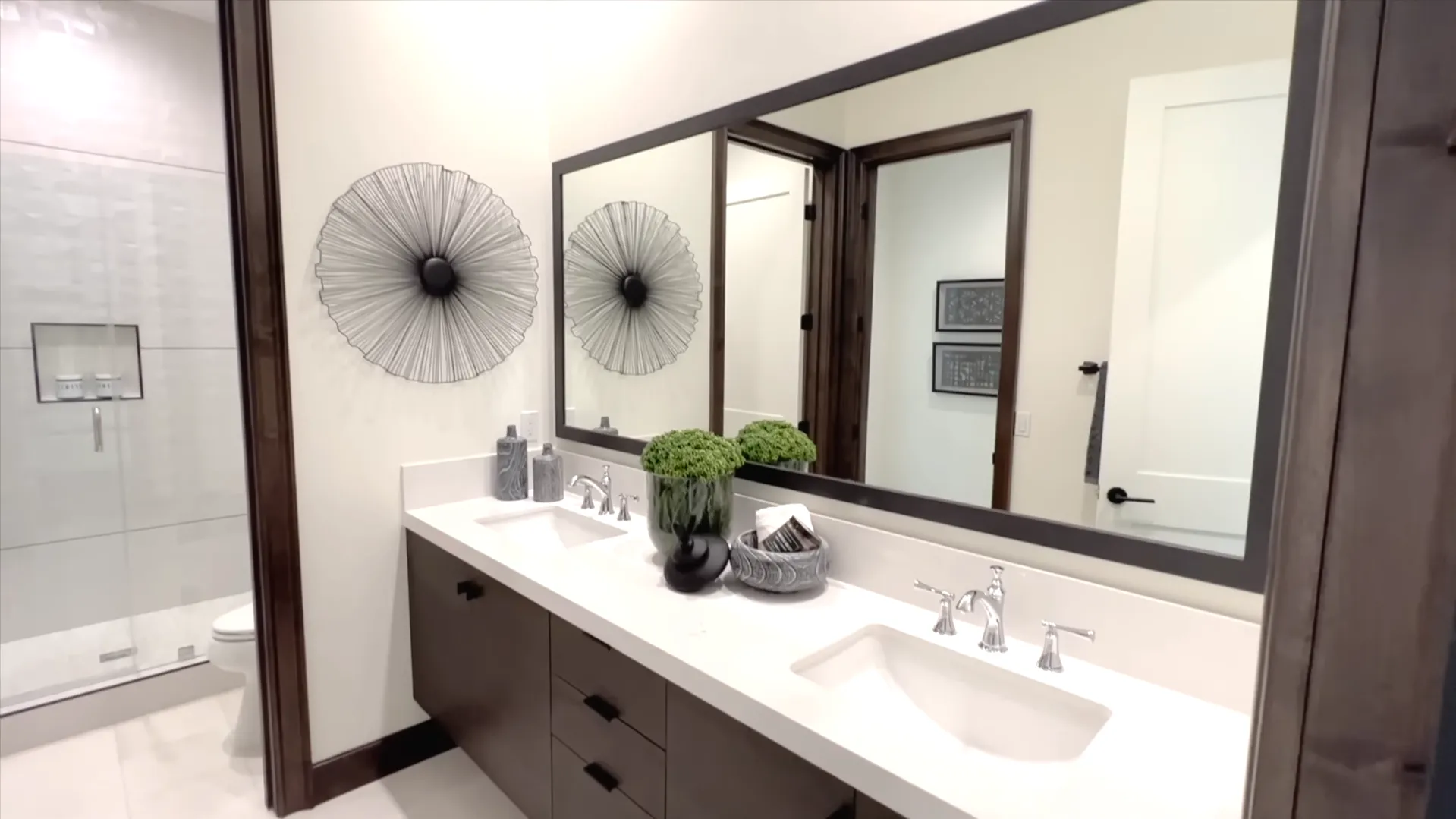 small and modern bathroom with double sinks.